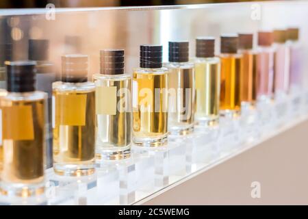 set of colorful perfume bottles in shop window. Stock Photo