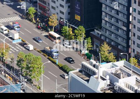 Aerial view of traffic in roads of Tokyo. A aisle in between skyscrapers. Close-up Stock Photo