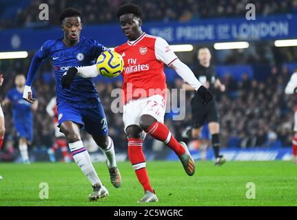 LONDON, ENGLAND - JANUARY 21, 2020: Callum Hudson-Odoi of Chelsea and Bukayo Saka of Arsenal pictured during the 2019/20 Premier League game between Chelsea FC and Arsenal FC at Stamford Bridge. Stock Photo
