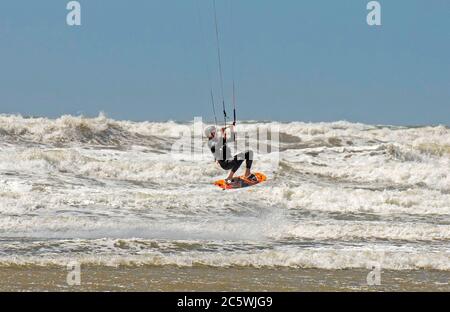 Llangennith Beach, Swansea, UK. 5th July, 2020. A solitary kite surfer makes the most of the windy conditions at Llangennith Beach on the Gower Peninsula near Swansea as the lockdown in Wales continues. Credit: Phil Rees/Alamy Live News Stock Photo