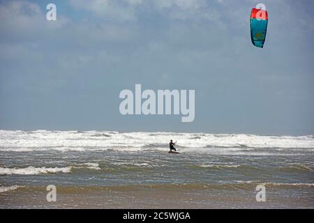 Llangennith Beach, Swansea, UK. 5th July, 2020. A solitary kite surfer makes the most of the windy conditions at Llangennith Beach on the Gower Peninsula near Swansea as the lockdown in Wales continues. Credit: Phil Rees/Alamy Live News Stock Photo