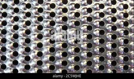 Abstract isolated macro of back of flat cheese grater texture Stock Photo