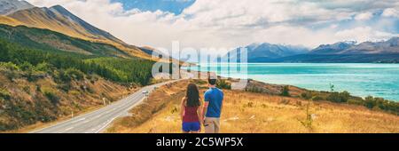 New Zealand travel people looking at Mount Cook Aoraki far in the landscape. Couple tourists walking at Peter's lookout, banner panorama copy space on Stock Photo