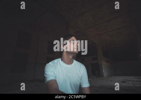 Young man posing in abandoned room Stock Photo