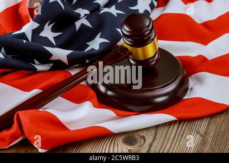 US legal office with USA lawyers in the judge's gavel on American flag Stock Photo