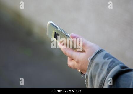 A woman's hand holding a mobile phone or cell phone Stock Photo