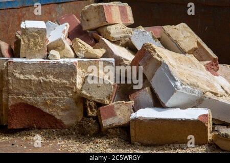 a pile of bricks and rubble that has been fly tipped from a broken brick wall Stock Photo