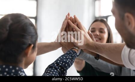 Excited staff members giving high five sharing success closeup image Stock Photo