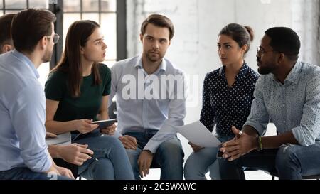 Diverse staff members gather together brainstorming solving working moments Stock Photo