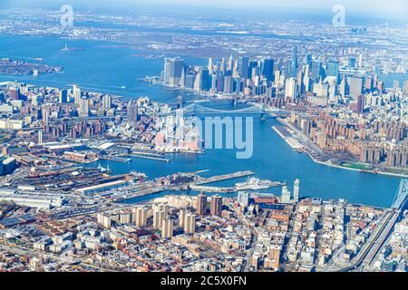 New York City,NYC LaGuardia Airport arriving flight,aerial overhead view from above,Brooklyn East Hudson River,Manhattan skyscrapers buildings skyline Stock Photo