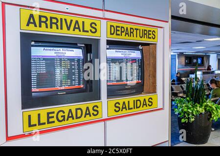 New York City,NYC NY Queens,LaGuardia Airport,LGA,terminal,American Airlines,flight information screen,arrivals,departures,bilingual,Spanish,English,m Stock Photo