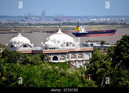 A view from Windmill Hill picturing the Guru Nanak Darbar Gurdwara with Seashark outbound on Gravesend Reach. Stock Photo