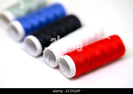 Thread spool set on white background. Basic color of threads: red, white, black. Simple thread spool perspective view. Tailoring service or sewing equ Stock Photo