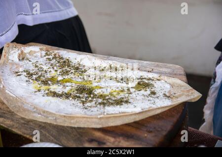 Traditional Druze Pita bread, baked on a metal Saj or Tava, with 'Labane' cheese, a  Middetrenian strained yogurt, and fresh Za'atar spice mixture.  D Stock Photo