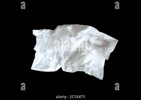 Used paper napkin isolated on black background. Crumpled tissue Stock Photo