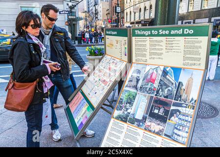 New York,New York City,NYC,Manhattan,Midtown,34th Street,Broadway,Herald Square,man men male adult adults,woman women female lady,couple,map,direction Stock Photo