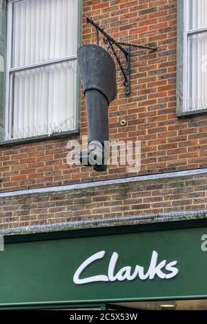 A large boot hanging sign outside Clarks shoe shop in East Street, Chichester.