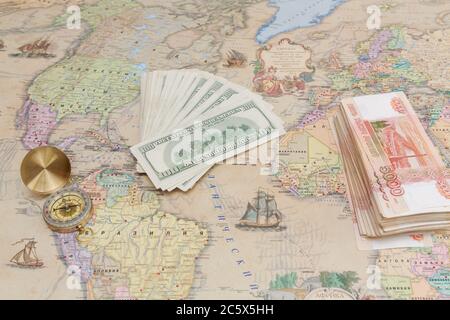 Compass with a bundle of big money are on the map Stock Photo