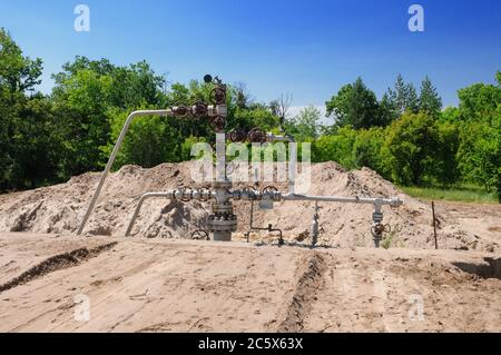 Preparation of a gas well for overhaul. Construction of the wellhead shaft and the platform for the installation of workover rig Stock Photo