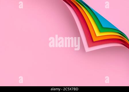 Rainbow colored papers with curled corners. Stack of multicolored papers and folded corners. Pages with corner curve. Stock Photo