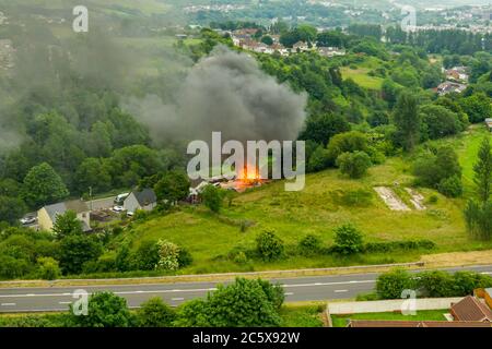 Aerial view of firefighters tackling a small blaze in a domestic outbuilding. The fire was extinguished within minutes Stock Photo