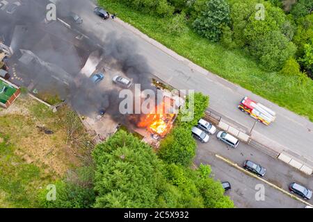 Aerial view of firefighters tackling a small blaze in a domestic outbuilding. The fire was extinguished within minutes Stock Photo