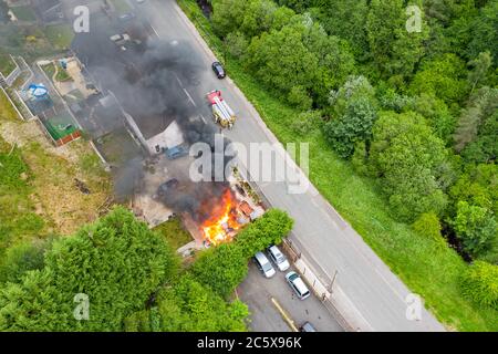 Aerial view of firefighters tackling a small blaze in a domestic outbuilding. The fire was extinguished within minutes Stock Photo