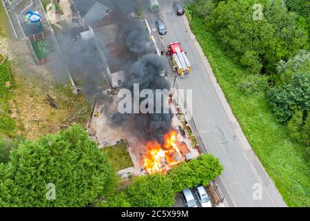 Aerial view of firefighters tackling a small blaze in a domestic outbuilding. The fire was extinguished within minutes Stock Photo