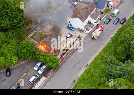 Aerial view of firefighters tackling a small blaze in a domestic outbuilding. The fire was extinguished within minutes Stock Photo