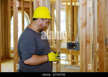 Electrical specialist checking inspects house electrical systems, electrician a house under construction Stock Photo