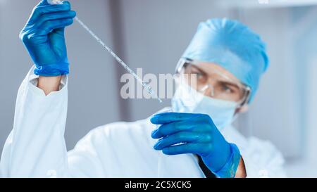 close up. scientist studying the liquid in a medical flask. Stock Photo