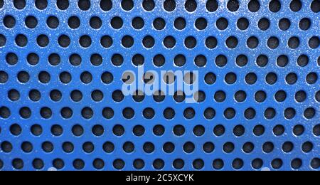 Blue metal background with black holes, metal mesh Stock Photo