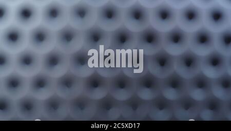 Blurred silver metal background with black holes, metal mesh Stock Photo