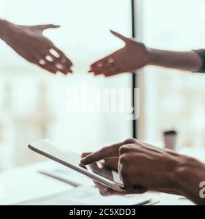 young woman using her smartphone at work in the office . Stock Photo