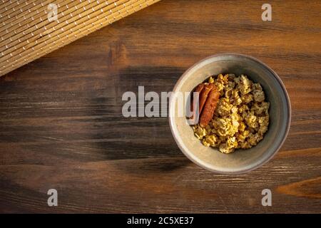 Top view of healthy food, granola bowl with pecan in wooden background and copy space Stock Photo
