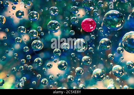 Uniqueness, standing out from the crowd abstract water drops in blue background Stock Photo