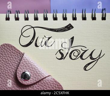 Our Stroy words lettering in copybook and wallet. Business story concept Stock Photo
