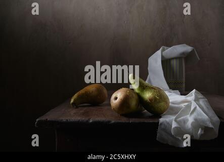 Green pears in drops of water. Still life in a low key Stock Photo