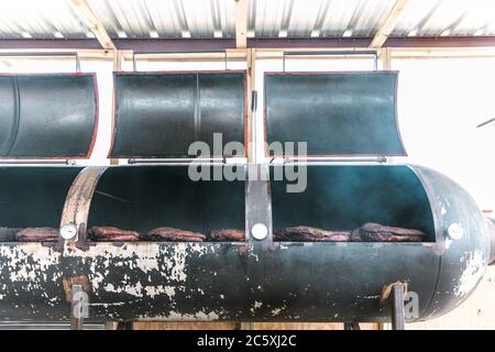 Briskets Cooking in a Smoker Stock Photo