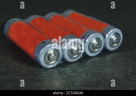 Packing electric alkaline batteries on a dark background. Stock Photo