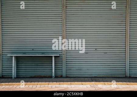 Metallic roller shutter door with desk Stock Photo