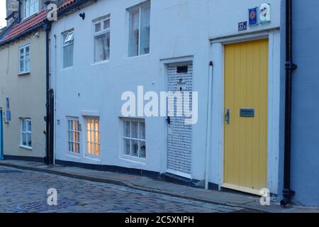 Henrietta Street in Whitby, North Yorkshire is comprised of holiday cottages and a Smoked Kippers shop. Stock Photo