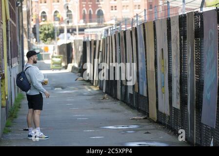 Vancouver, Canada. 5th July, 2020. A man looks at murals during the Murals of Gratitude Exhibition at Gastown in Vancouver, British Columbia, Canada, July 5, 2020. The exhibition showcased 35 murals completed by more than 20 artists to honour the frontline health workers fighting against the COVID-19 pandemic. Credit: Liang Sen/Xinhua/Alamy Live News Stock Photo