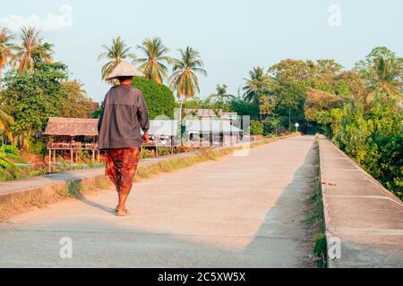 People walking on the historical bridge between Don Det and Don Khon. built by the French on the Mekong river in Laos Stock Photo