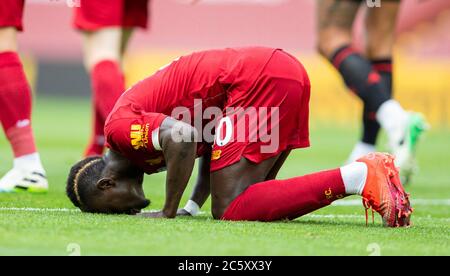 Liverpool. 6th July, 2020. Liverpool's Sadio Mane kneels to celebrates after scoring the Premier League match between Liverpool and Aston Villa at Anfield in Liverpool, Britain on July 5, 2020.FOR EDITORIAL USE ONLY. NOT FOR SALE FOR MARKETING OR ADVERTISING CAMPAIGNS. NO USE WITH UNAUTHORIZED AUDIO, VIDEO, DATA, FIXTURE LISTS, CLUB/LEAGUE LOGOS OR 'LIVE' SERVICES. ONLINE IN-MATCH USE LIMITED TO 45 IMAGES, NO VIDEO EMULATION. NO USE IN BETTING, GAMES OR SINGLE CLUB/LEAGUE/PLAYER PUBLICATIONS. Credit: Xinhua/Alamy Live News