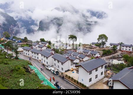 Beijing, China. 30th June, 2020. Aerial photo taken on June 30, 2020 shows the newly built road and a relocation site in Abuluoha Village, Liangshan Yi Autonomous Prefecture of southwest China's Sichuan Province. Credit: Jiang Hongjing/Xinhua/Alamy Live News Stock Photo