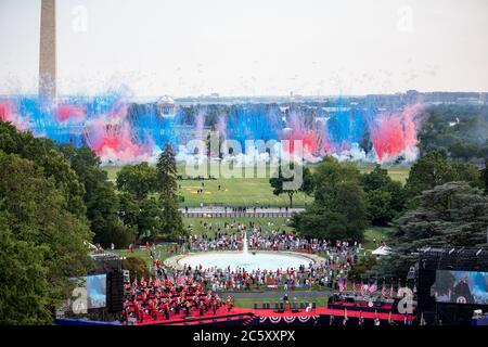 Washington, United States Of America. 04th July, 2020. President Donald J. Trump, First Lady Melania Trump, and guests look on as smoke from red, white, and blue fireworks is seen on the Ellipse Saturday, July 4, 2020, during the 2020 Salute to America event on the South Lawn of the White House People: President Donald Trump, Melania Trump Credit: Storms Media Group/Alamy Live News Stock Photo