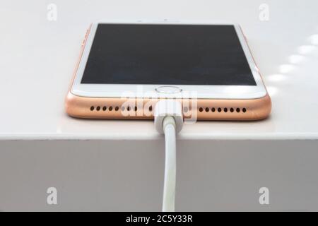 Calgary, Alberta. Canada July 5, 2020. An iPhone Plus charging with a lightning USB Cable. Stock Photo