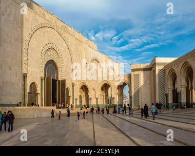 Casablanca, Morocco - December 09, 2012: People in front of the third largest mosque in the world, Mosque Hassan II at sunset Stock Photo