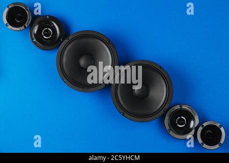 Car audio, car speakers, black subwoofer on a blue background. Copy space Stock Photo